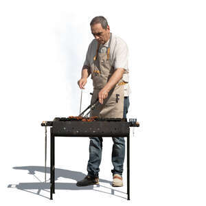man cooking over an outdoor grill