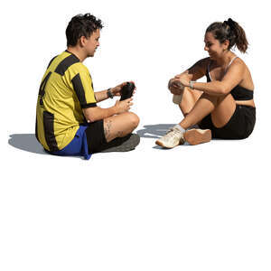 man and woman sitting on the ground and resting after workout