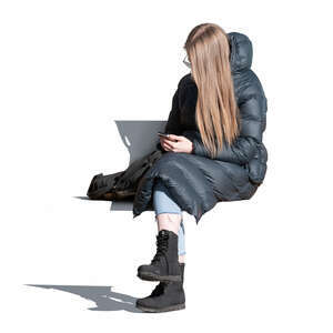 woman in a puffy overcoat sitting