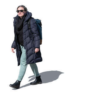 woman with a backback and sunglasses walking