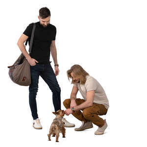 two men and a little dog standing