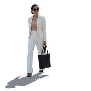 backlit woman wearing a white suit walking