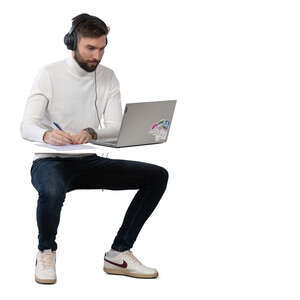 man working at a desk with computer