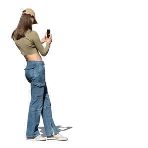 woman with a baseball hat standing and taking a picture