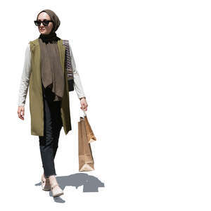 elegant muslim woman with shopping bags walking