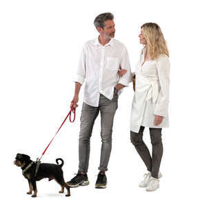 man and woman with a dog standing