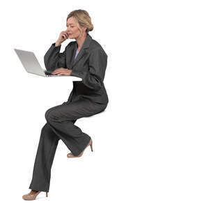 woman sitting at a counter table and working with laptop