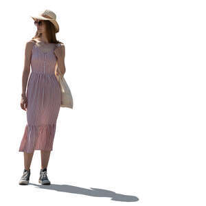 backlit woman in a summer dress standing