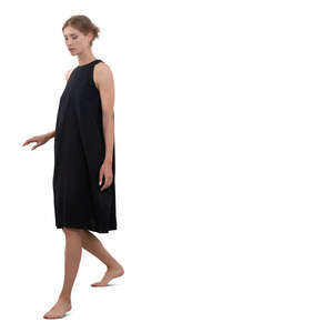 woman in a black dress walking barefoot down the stairs
