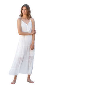 woman in a white dress standing barefoot