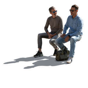 backlit men sitting and talking