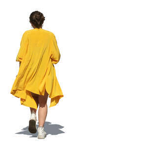 woman in a yellow flowy jacket walking