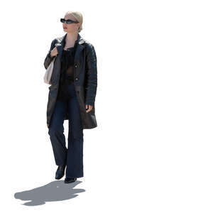 backlit woman wearing a leather jacket walking