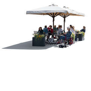 backlit street cafe with parasols and people