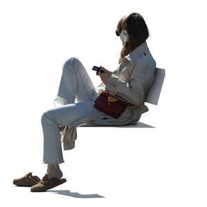 backlit woman sitting and listening to music
