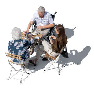man in a wheelchair sitting in a cafe with his friends seen from above