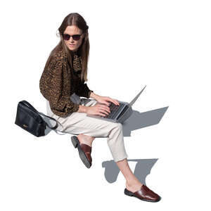 woman with laptop sitting outside seen from above