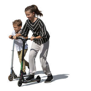 two kids with scooters riding happily