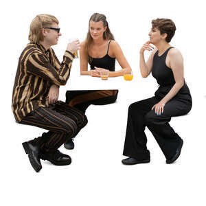 group of three people sitting and talking in a coffeeshop