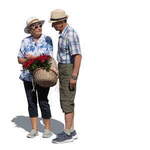 elderly couple with a basket of flowers standing