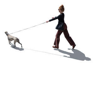 backlit woman running after a dog