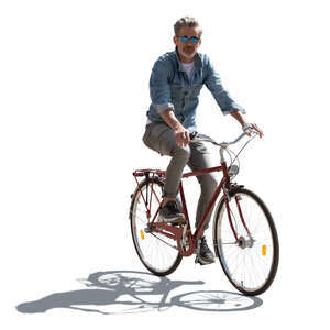 backlit man riding a bicycle