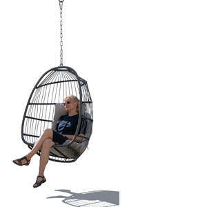 backlit woman relaxing in the hanging chair