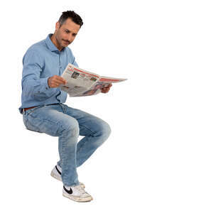 man with moustache sitting and reading a newspaper