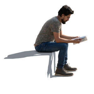 man sitting outside and reading