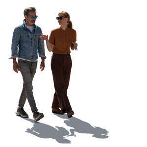 backlit man and woman walking and talking