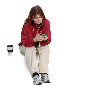 woman sitting and listening to music and drinking coffee