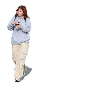 teenage girl walking and drinking coffee