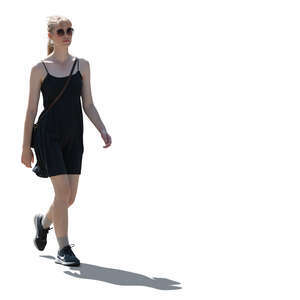 backlit woman in a black mini dress walking