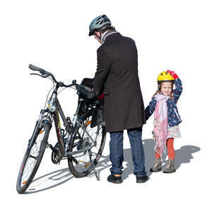 man and his daughter preparing to go bike riding