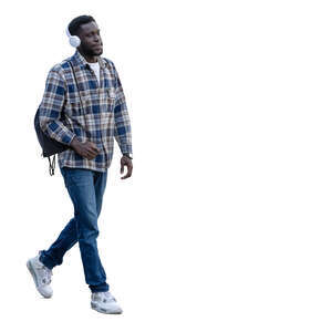 young black man with headphones and backpack walking