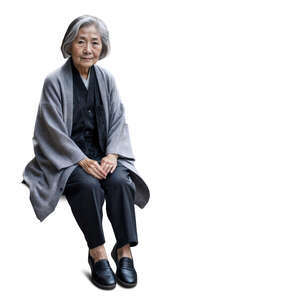 elderly asian woman wearing a grey jacket sitting