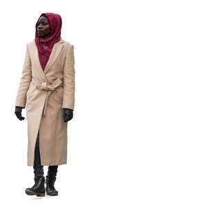 black woman wearing a camel overcoat walking