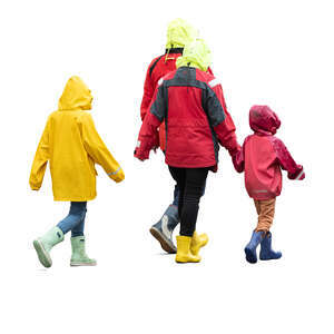 family with kids wearing rain coats walking