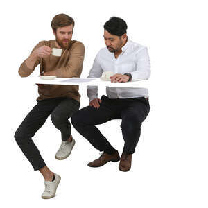 two men sitting in a coffee bar and talking