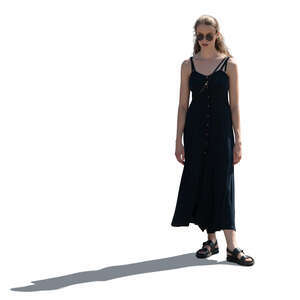 backlit woman in a black dress standing