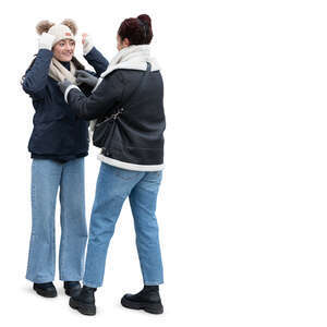 two young women standing outside in winter