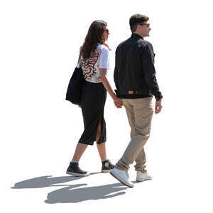 backlit man and woman walking holding hands