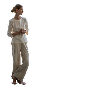 woman looking out the window and drinking coffee