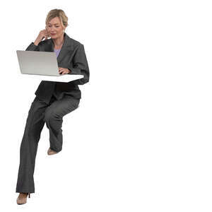 woman sitting at a counter table and working with laptop