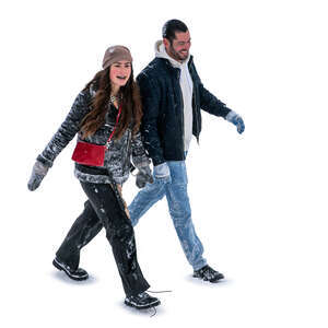 man and woman covered with snow walking seen from above