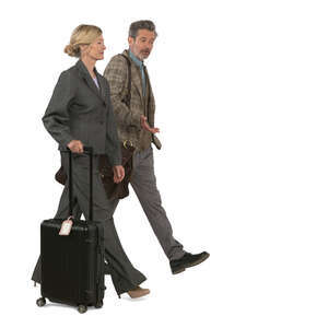 man an woman with suitcases and bags walking