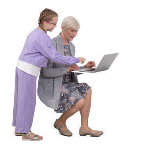 grandchild helping her grandmother with computer