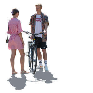 two cut out backlit people with a bike standing