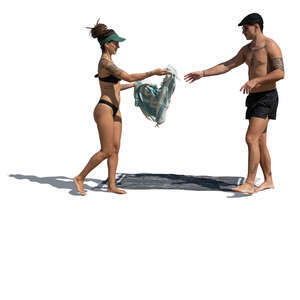 couple preparing to sunbathe on the beach