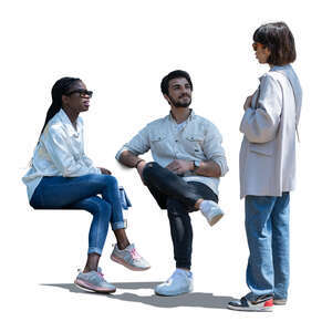 woman talking to two friends sitting in partial shade